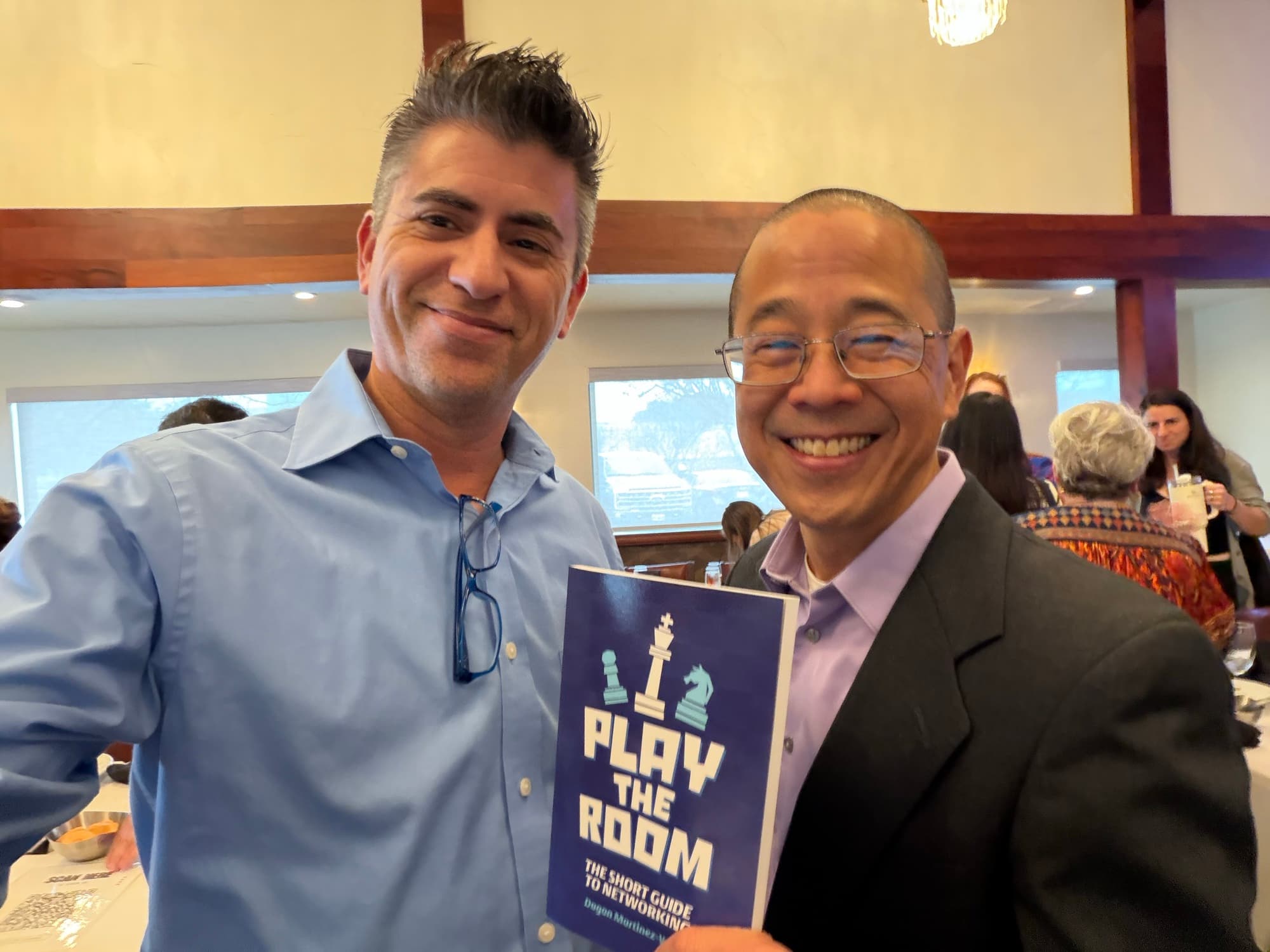 Dagan Martinez-Vargas with a reader holding a copy of Play the Room