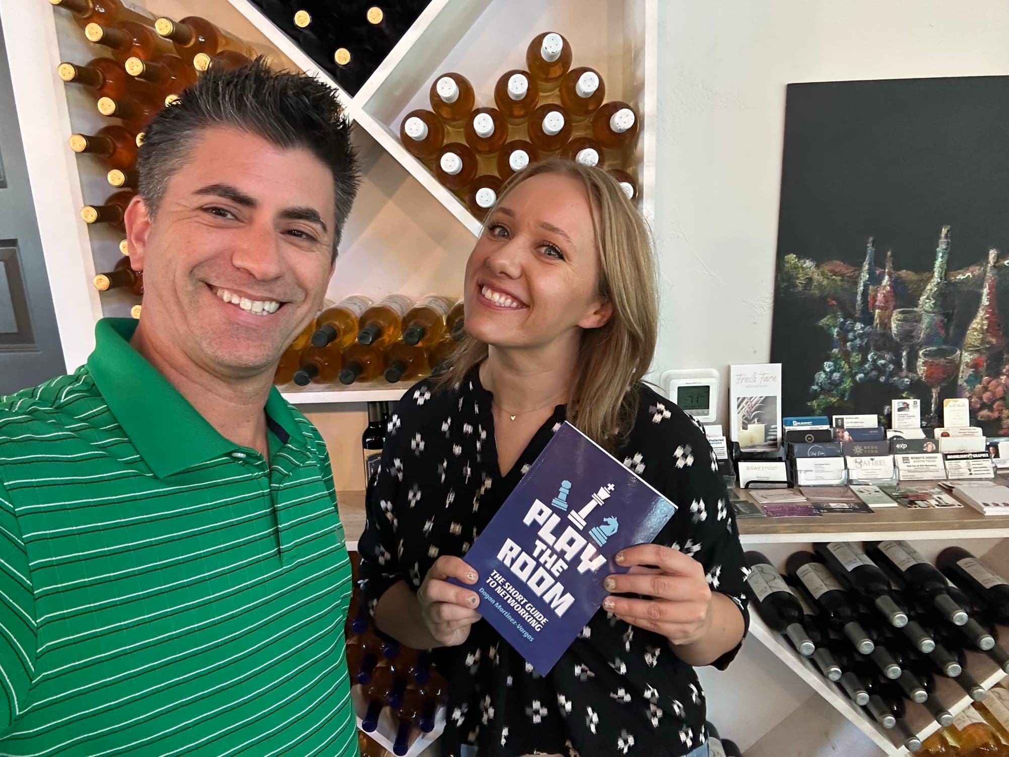 Dagan Martinez-Vargas with a reader holding a copy of Play the Room
