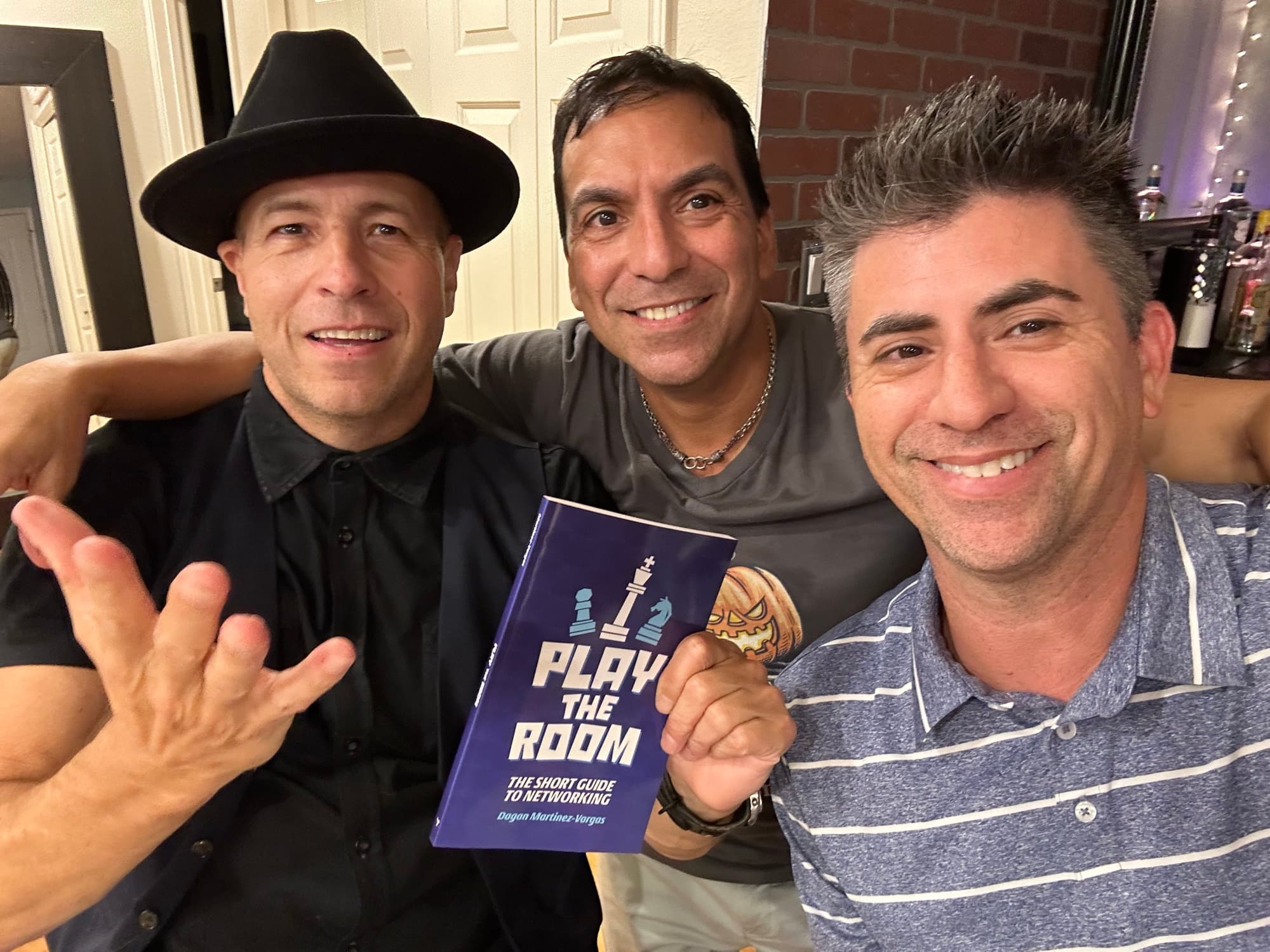 Dagan Martinez-Vargas with a reader holding a copy of Play the Room