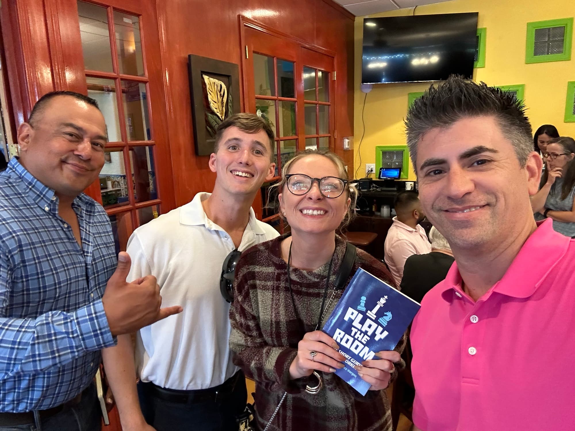 Dagan Martinez-Vargas with a reader holding a copy of Play the Room