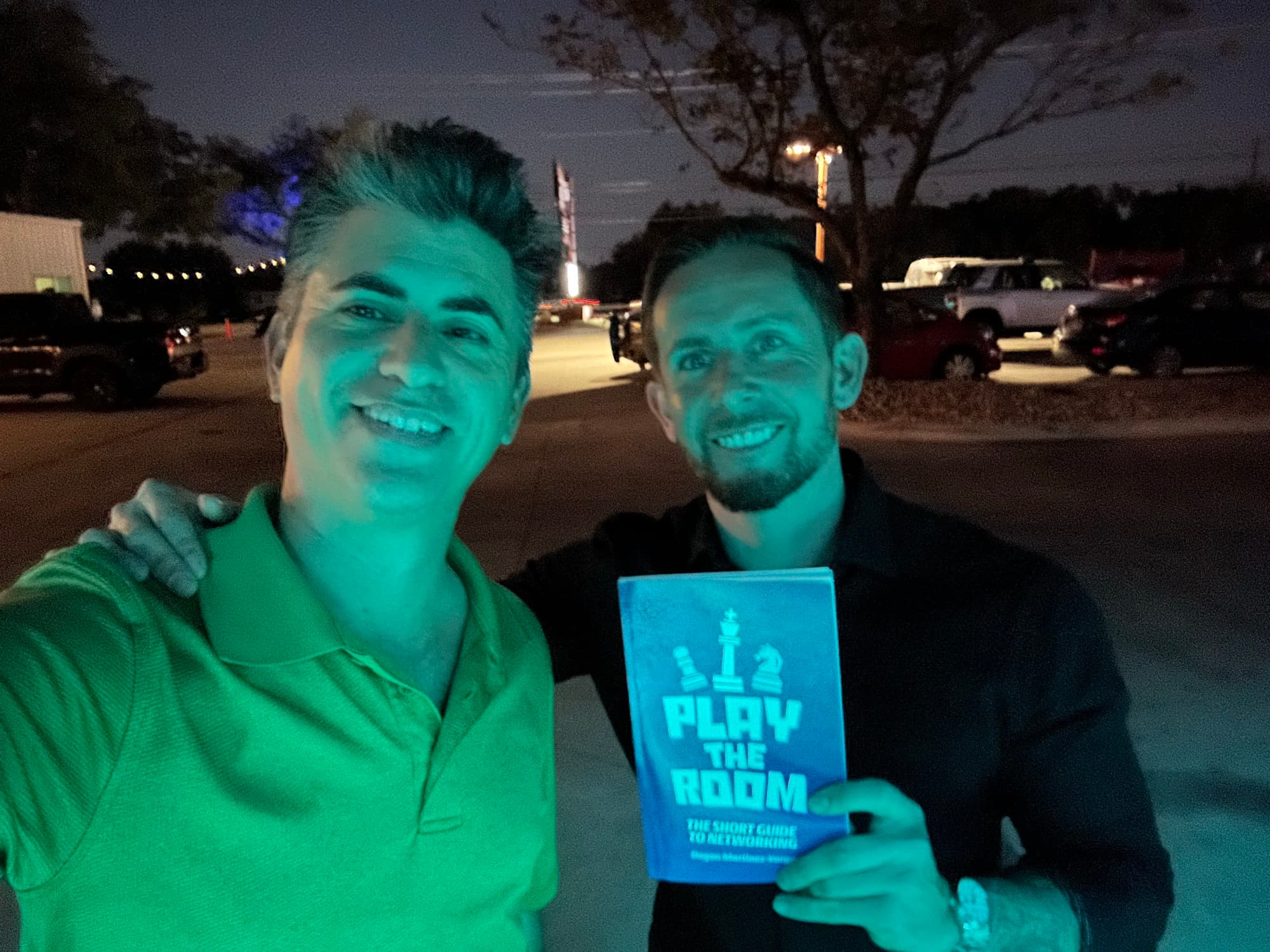 Dagan Martinez-Vargas with a reader holding a copy of Play the Room