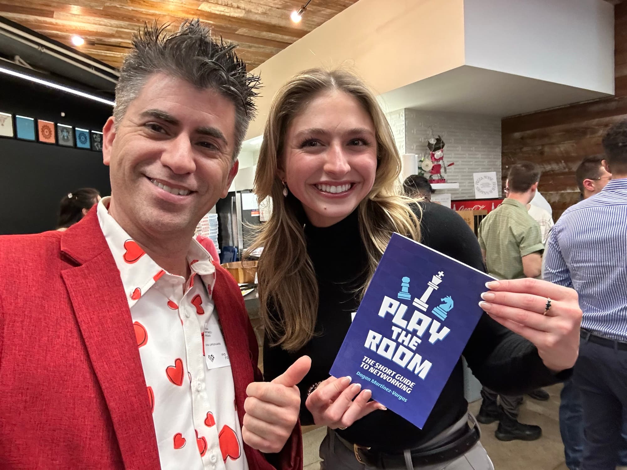 Dagan Martinez-Vargas with a reader holding a copy of Play the Room