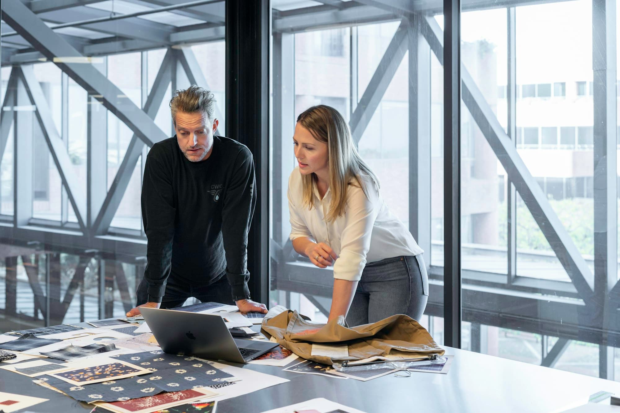Two professionals working through a plan at a table